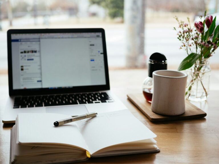 Daily task tracker in Excel planning workspace with laptop and notebook
